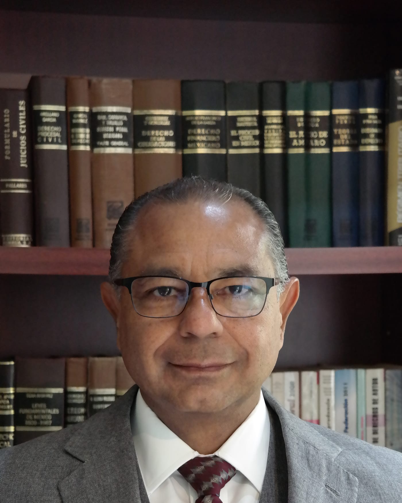 Lic. Mauricio A. Ramírez R., titular de la firma, en la biblioteca del despacho